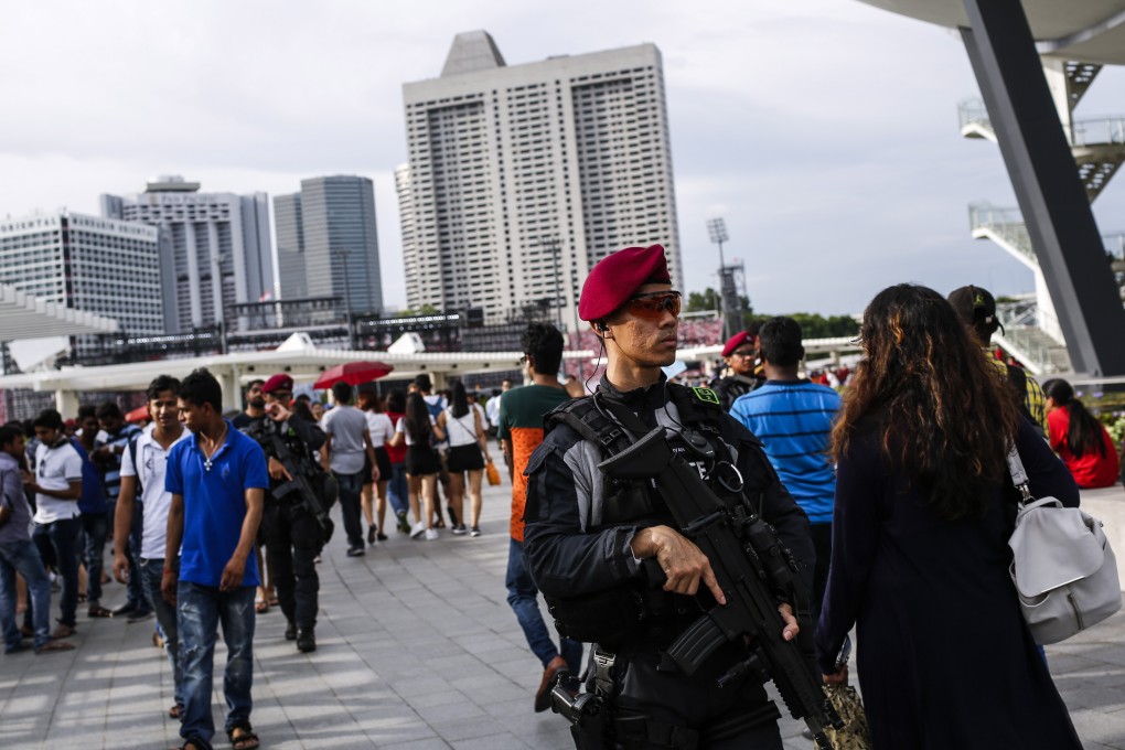 An officer (right) from the Singapore Police Force’s Special Operations Command patrols a walkway along Marina Bay. A case in which a domestic worker was accused of theft that was overturned by Singapore’s High Court has raised questions over how police and other agencies dealt with the complaint. Photo: EPA-EFE