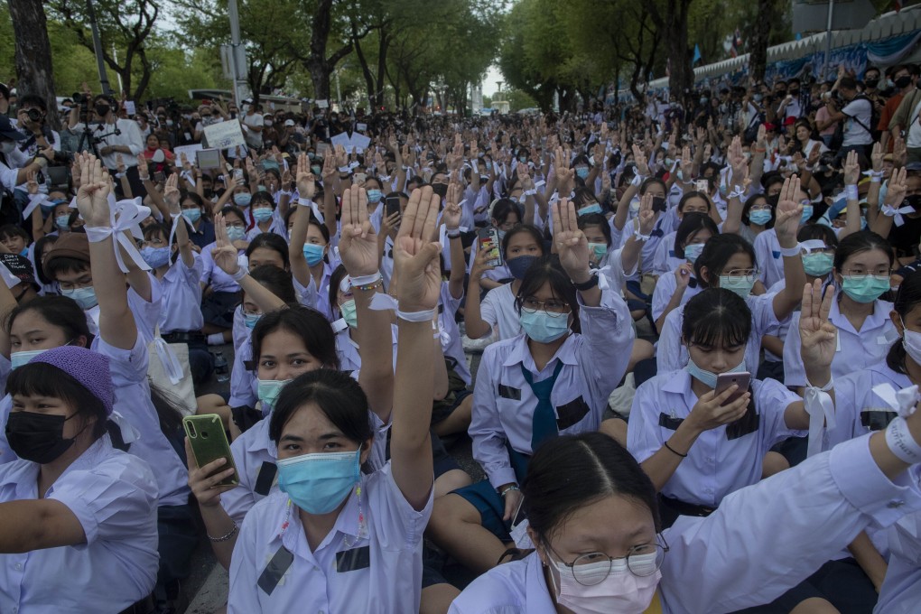High school students salute with three-fingers, symbol of resistance during a protest rally in Bangkok, Thailand. Photo: AP