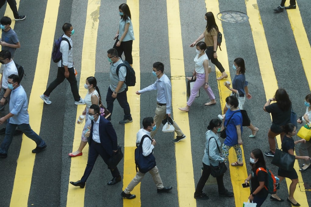 People cross a street in Central district on June 29. The government’s finances would struggle to provide another round of universal relief. Photo: Winson Wong