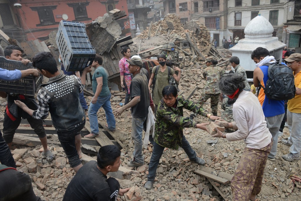 People clear rubble in Kathmandu’s Durbar Square, a Unesco World Heritage Site, after a massive 7.8 magnitude earthquake ripped through large parts of Nepal in April, 2015. Astrology is being used to guide the ongoing restoration programme in Kathmandu. Photo: AFP