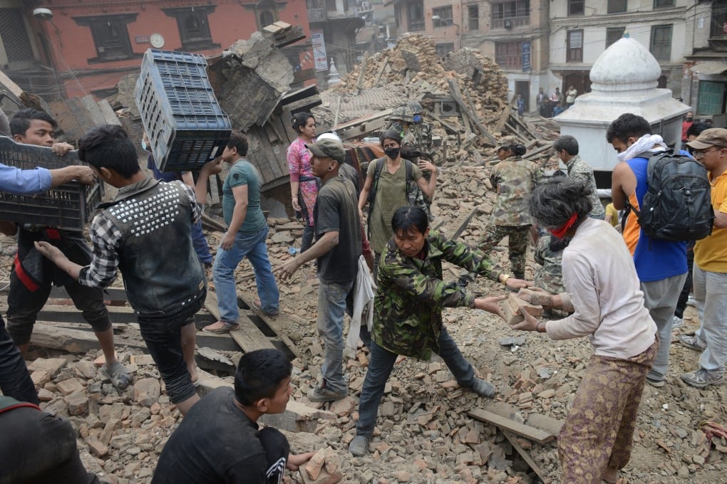 People clear rubble in Kathmandu’s Durbar Square, a Unesco World Heritage Site, after a massive 7.8 magnitude earthquake ripped through large parts of Nepal in April, 2015. Astrology is being used to guide the ongoing restoration programme in Kathmandu. Photo: AFP
