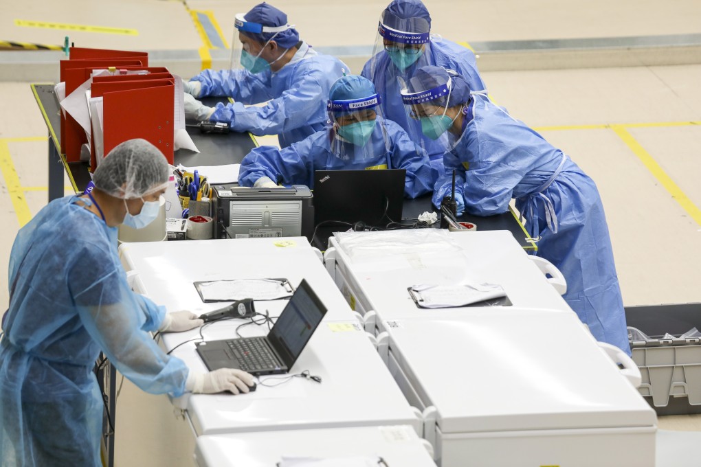 Mainland health experts work at the makeshift lab at the Sun Yat Sen Memorial Park Sports Centre on Saturday. Photo: Xiaomei Chen