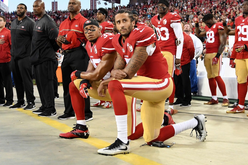 Colin Kaepernick and Eric Reid of the San Francisco 49ers kneel in protest during the national anthem prior to playing the Los Angeles Rams on September 12, 2016. Photo: AFP