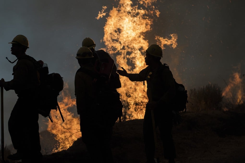 Firefighters monitor a controlled burn along Nacimiento-Fergusson Road to help contain the Dolan Fire near Big Sur, California. Photo: AP
