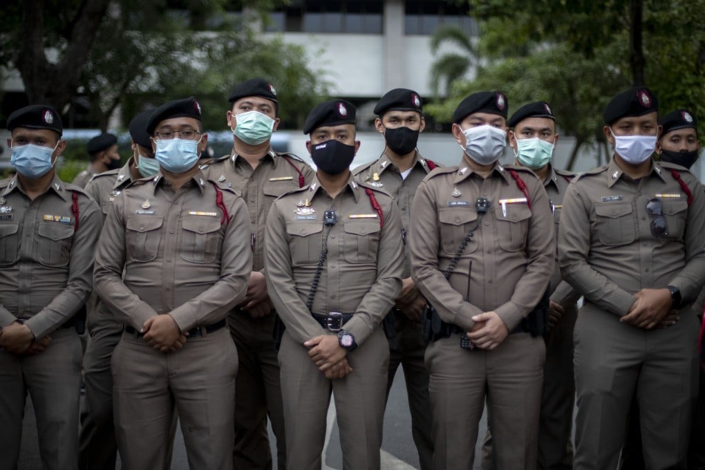 Police officers stand guard at the criminal courthouse in Bangkok. Photo: AP