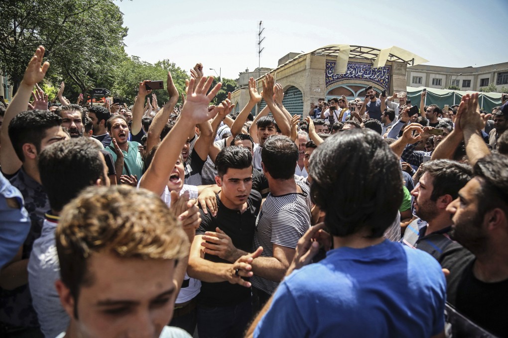 People chant slogans during a protest rally in Tehran in 2018. Photo: AP