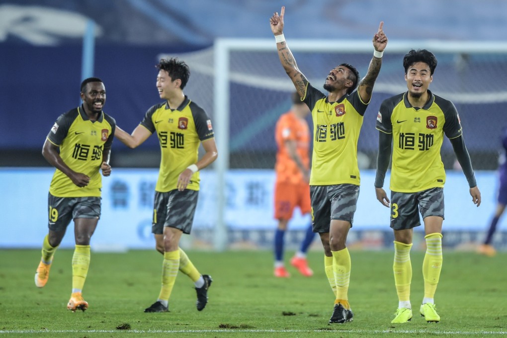 Paulinho (second from right) of Guangzhou Evergrande celebrates scoring against Shandong Luneng in the Chinese Super League. Photo: Xinhua