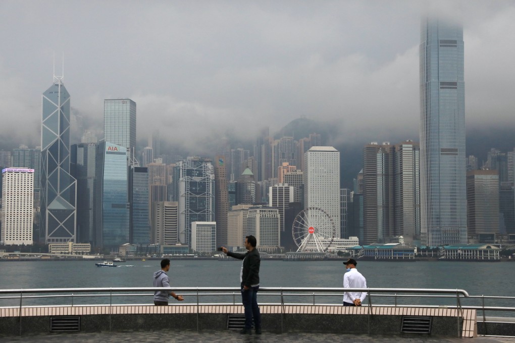 People pose for a photo at the Tsim Sha Tsui waterfront, a popular attraction among tourists in Hong Kong. Photo: May Tse