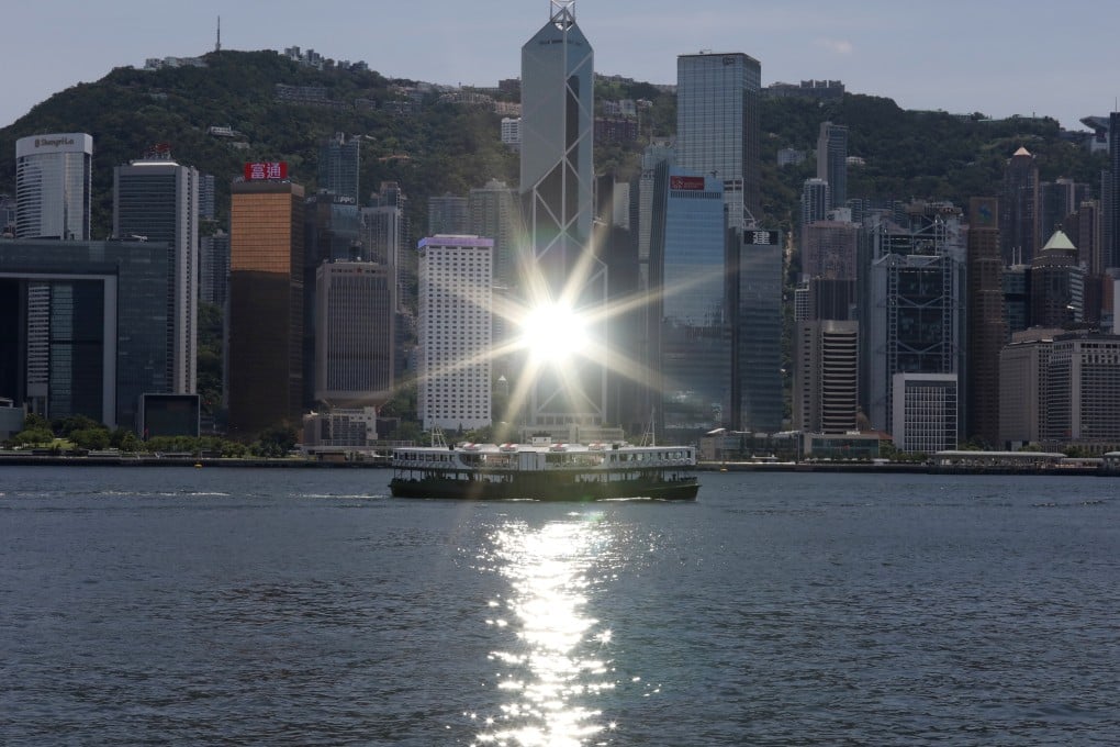 The sunlight is reflected off the Bank of China tower located in Central, Hong Kong, as a Star Ferry crosses Victoria Harbour on July 14. Photo: Nora Tam