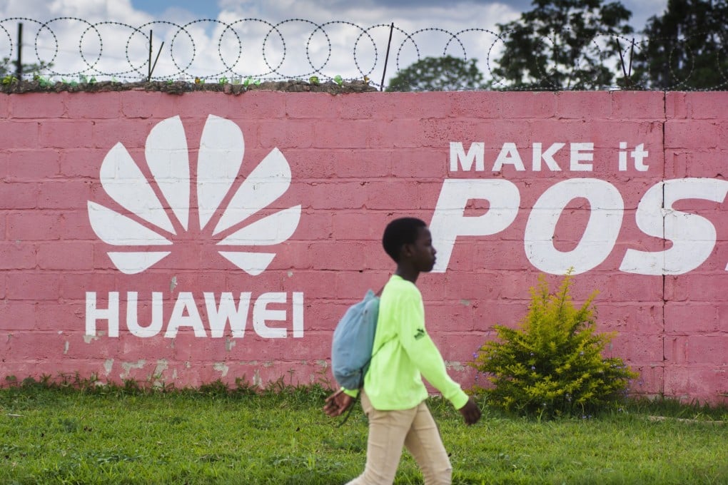 A pedestrian passes the Huawei logo painted on a wall in Lusaka, Zambia, on December 11, 2018. Many digital infrastructure projects in Zambia, like the more visible airport terminals and highways, are being built and financed by China. Photo: Bloomberg