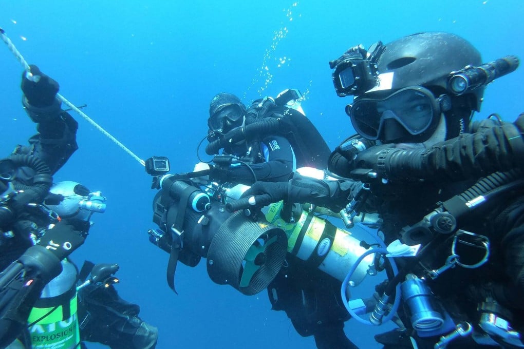 Divers at work in the Strait of Malacca. Photo: AP