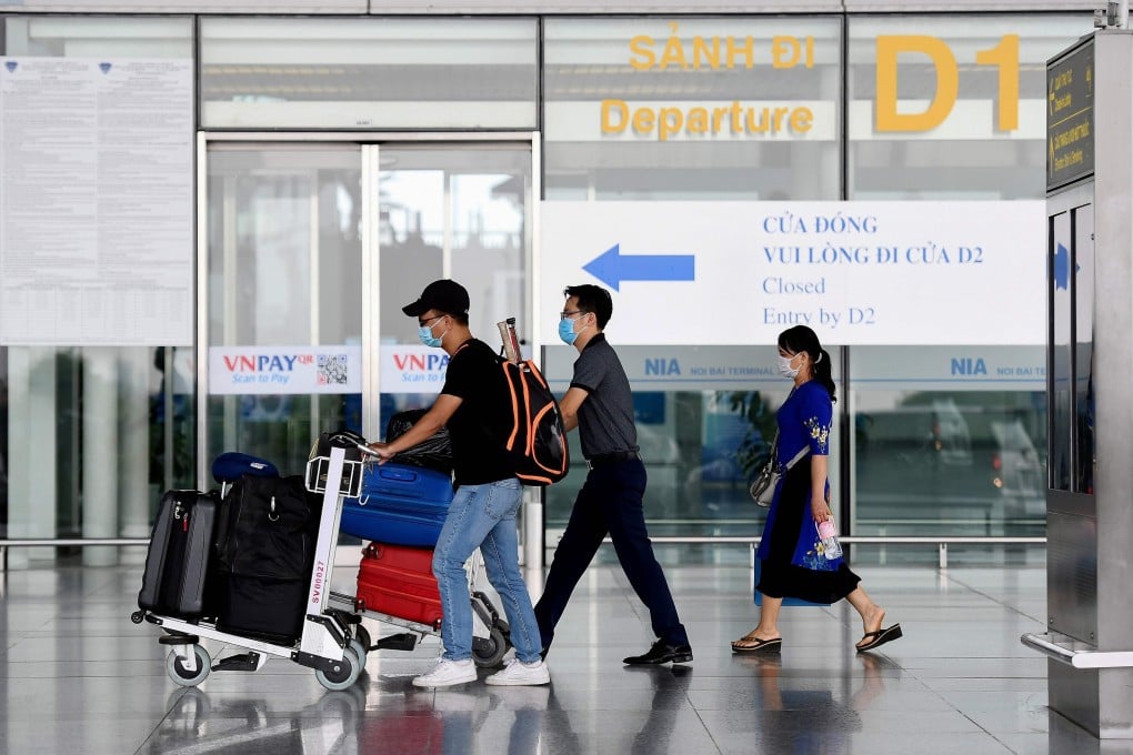 Passengers walk with their luggage at the departure terminal at Noi Bai International Airport in Hanoi on Wednesday. Photo: AFP
