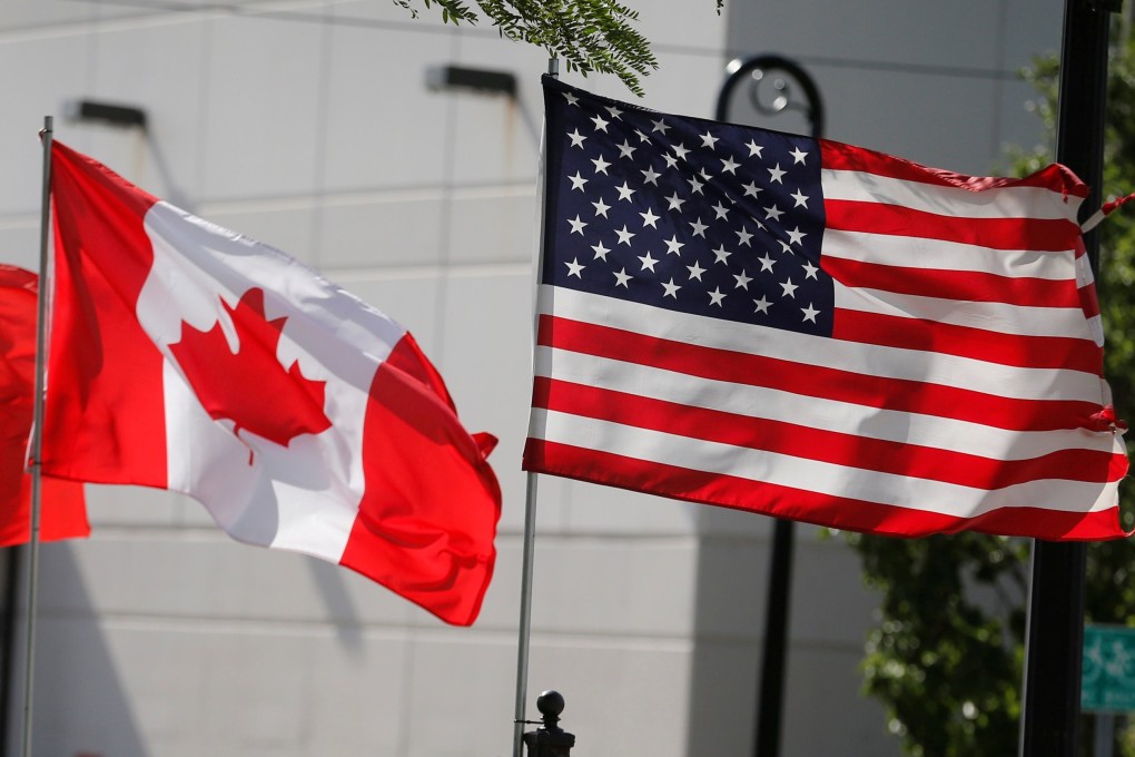 US and Canada flags fly in Detroit. The US said last month that an influx of Canadian aluminium was the reason for a 10 per cent tariff. Photo: Reuters