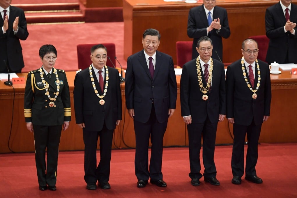 Major General Chen Wei who is leading the search for one of China’s vaccine candidates, Chinese medicine expert Zhang Boli, President Xi Jinping, respiratory medicine specialist Zhong Nanshan, and former dean of Wuhan Jinyintan Hospital Zhang Dingyu during a ceremony in Beijing on September 8. Photo: AFP