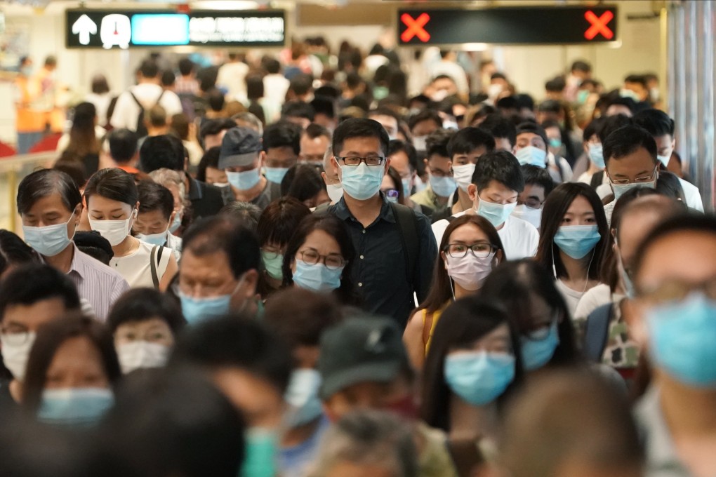 Commuters change platforms on the East Rail Line on July 14. The government should tighten social distancing measures now so we do not pay a bigger price later. Photo: Felix Wong