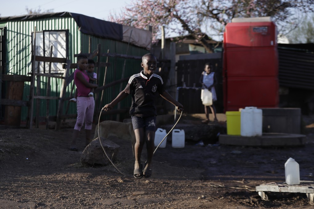 A child skips with a rope outside shacks in the Katlehong Township near Johannesburg. Studies suggest South Africans may have developed immunity to coronavirus. Picture: AP Photo