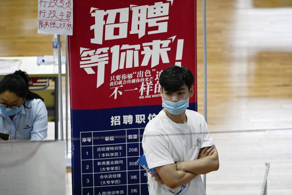 A jobseeker looking at a job announcement flyer during a career fair in Zhengzhou, China's Henan province on July 25. Photo: Agence France-Presse