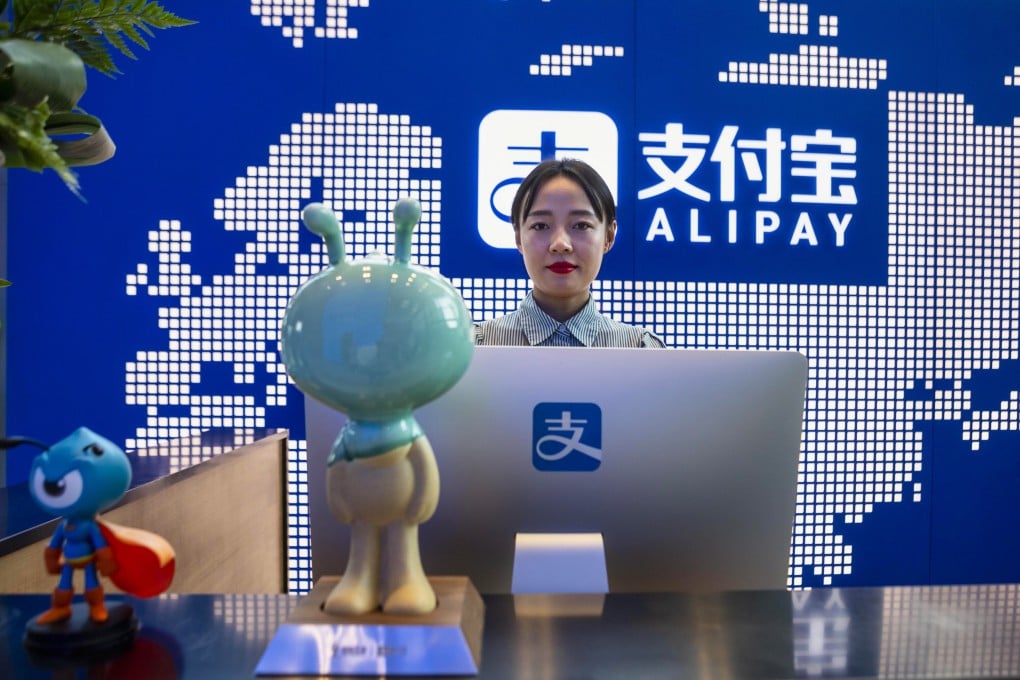 An employee stands at the reception desk of the Alipay and Ant Group headquarters building in Shanghai. Photo: EPA-EFE