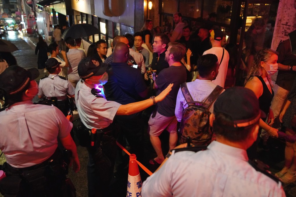 Police officers patrol a bar area in Central as patrons start to gather. Photo: Winson Wong