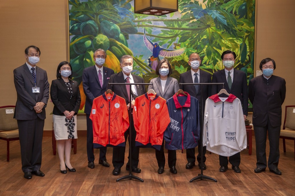 Former Japanese prime minister Yoshiro Mori (centre left) and Taiwan’s President Tsai Ing-wen (centre right) pose with signed Japan and Taiwan athletes’ uniforms for the Tokyo Olympics. Photo: Taiwan Presidential Office via AP