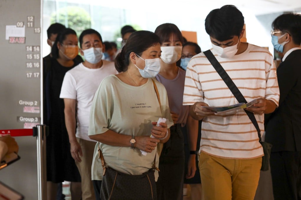Homebuyers line up for the sale of the second phase of the Wetland Seasons Park development in Tin Shui Wai, at the project’s sales office in International Commerce Centre in Kowloon on 19 September 2020. Xiaomei Chen