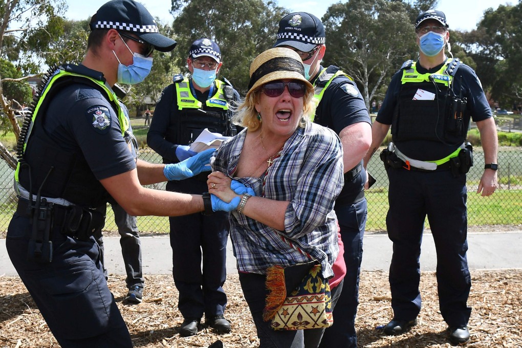 Police detain an anti-lockdown protester in Melbourne on September 19, 2020. Photo: AFP