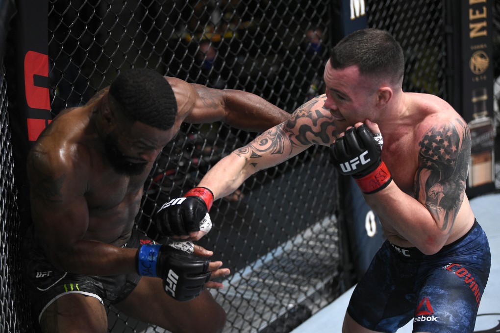 Colby Covington punches Tyron Woodley in their welterweight bout during the UFC Fight Night event at UFC APEX in Las Vegas, Nevada. Photo: Chris Unger/Zuffa LLC