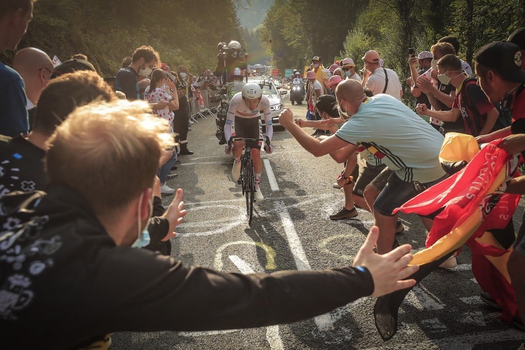 Spectators cheer for Slovenian rider Tadej Pogacar as he completes stage 20 of the Tour de France. Photo: EPA