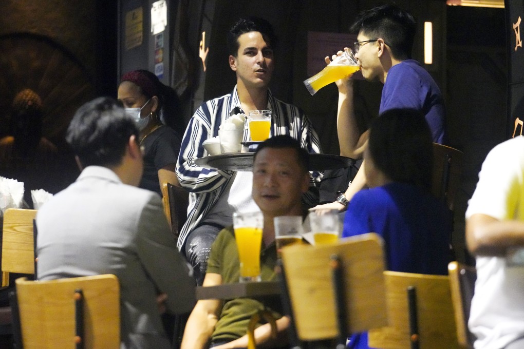 People drink at a bar in Central on Friday after the venues were allowed to resume operation. Photo: Winson Wong