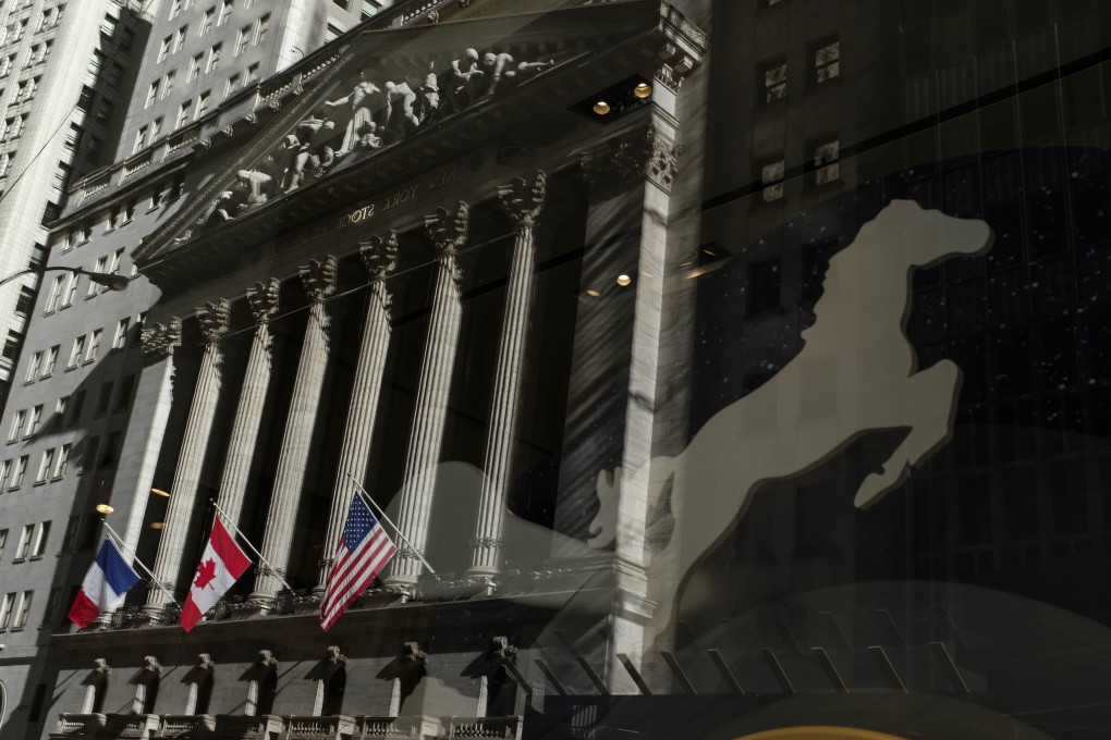 The New York Stock Exchange is reflected in a store window. Chinese firms continue to raise large sums of money in the US despite worsening relations. Photo: AFP/Getty Images