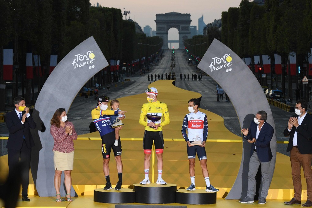 Slovenia’s Tadej Pogacar, of Team UAE Emirates, celebrates on the podium between Team Jumbo rider Primoz Roglic (left), of Slovenia, and Team Trek rider Richie Porte, of Australia, after winning the 107th edition of the Tour de France. Photo: AFP