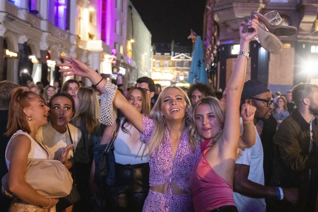 People sing and dance in London's West End on Saturday before the ‘rule of six’ restrictions come into force. Photo: AP
