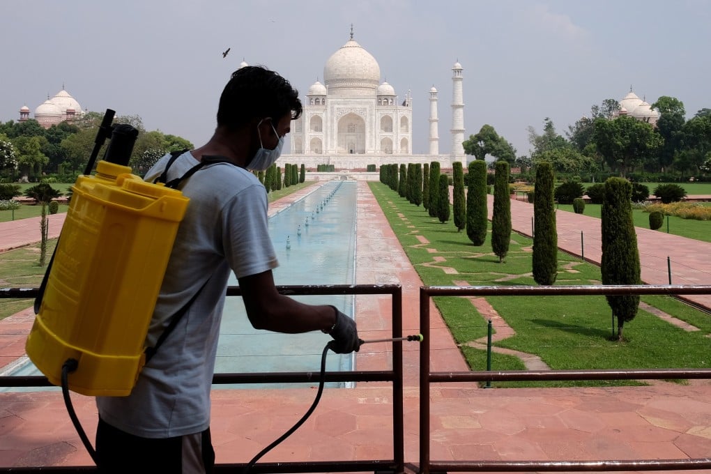 A worker sanitises railings at the Taj Mahal in Agra, India, after authorities reopened the famous monument to visitors. Photo: Reuters