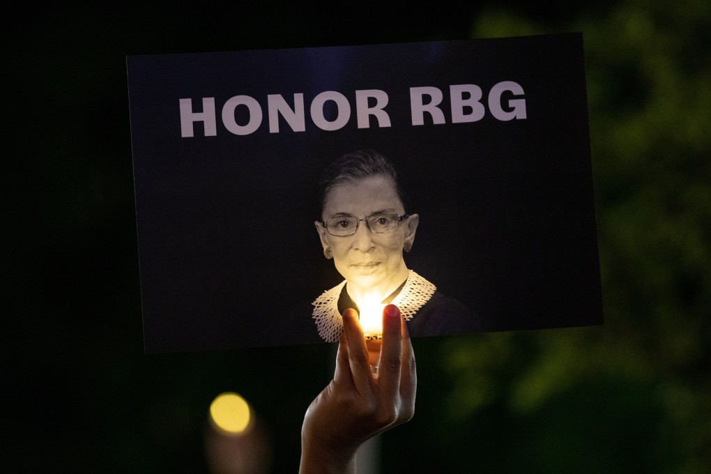 A mourners holds up a sign at a makeshift memorial during a vigil for Supreme Court Justice Ruth Bader Ginsburg outside of the Supreme Court in Washington, D.C. Photo: Bloomberg