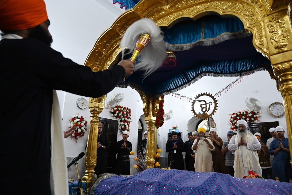 Sikh pilgrims take part in a religious ritual on the occasion of the 481st death anniversary of Guru Nanak at Gurdwara Darbar Sahib in Kartarpur, near the India-Pakistan border on Tuesday. Photo: AFP