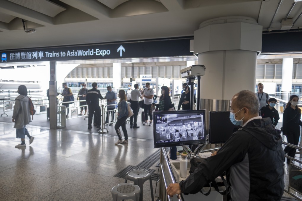 A member of staff watches thermographic images as travellers pass a temperature screening point at the Hong Kong International Airport on March 10. Photo: Bloomberg