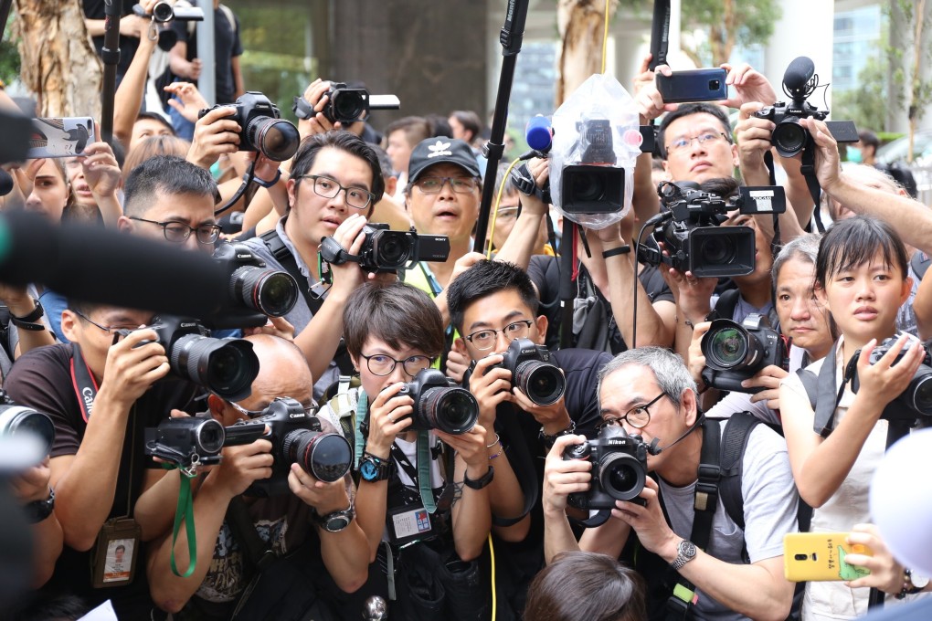 Reporters last year taking pictures of protesters outside the British consulate in Hong Kong. Photo: Rachel Cheung