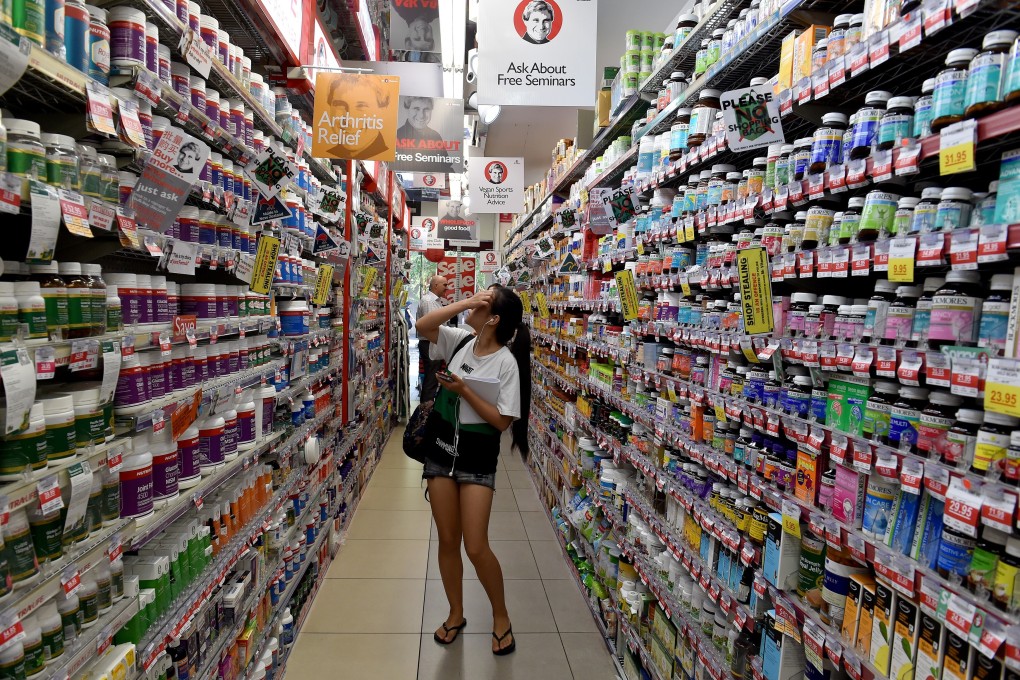 A shopper browsing through shelves of health supplements in a supermarket in Sydney. Photo: AFP