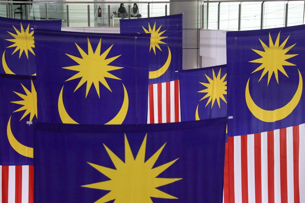 Giant Malaysian national flags hang inside a shopping centre. This year’s Sabah state election has been seen as a bellwether for Malaysian politics in general. Photo: EPA