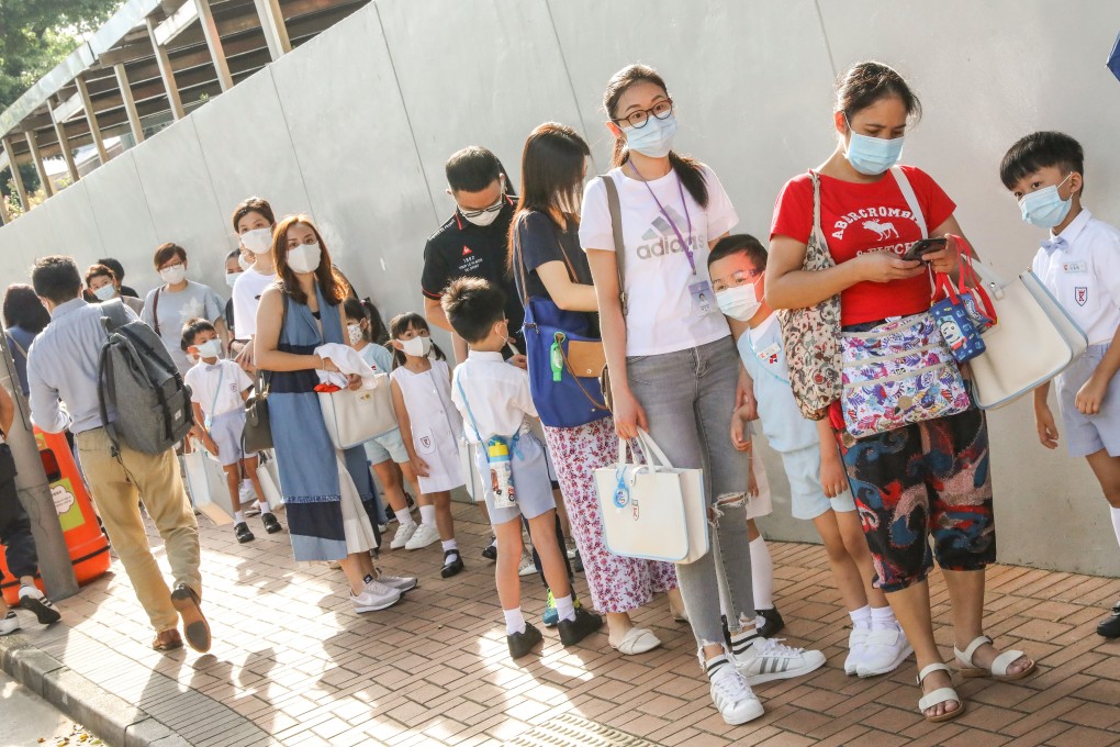 Students and parents line up outside Kingston International School in Kowloon Tong. Photo: K.Y. Cheng