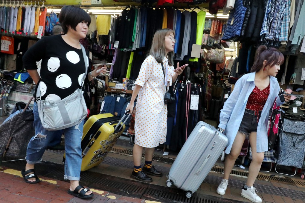 Daigou, or professional shoppers, like these in Sheung Shui, a town in Hong Kong near the Chinese border, buy goods overseas for Chinese consumers and offer low prices by dodging import taxes. Photo: Felix Wong
