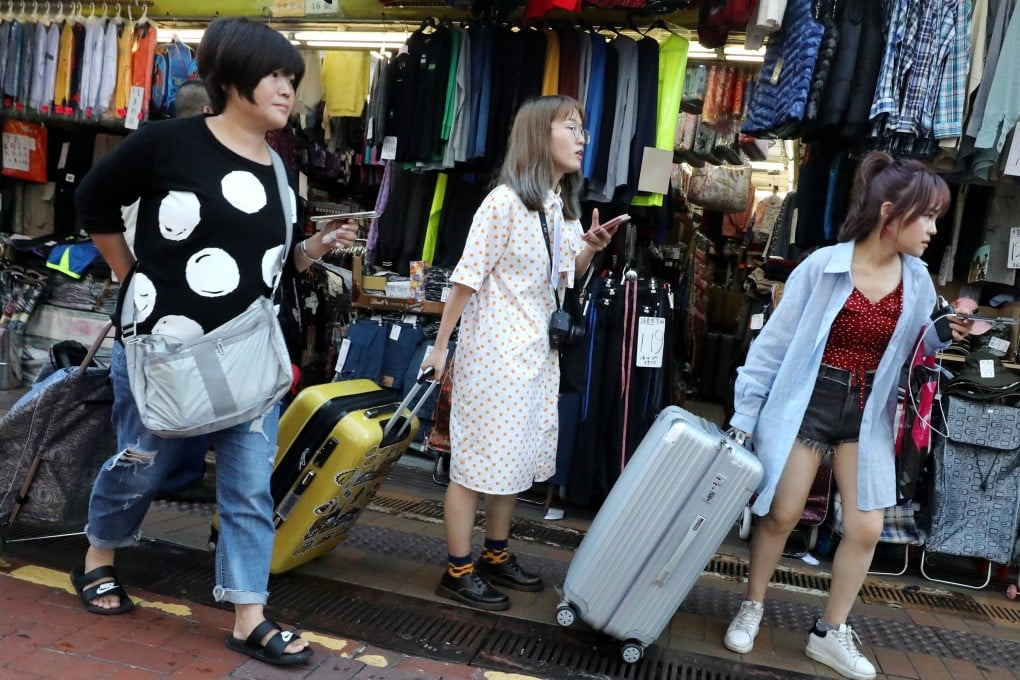 Daigou, or professional shoppers, like these in Sheung Shui, a town in Hong Kong near the Chinese border, buy goods overseas for Chinese consumers and offer low prices by dodging import taxes. Photo: Felix Wong