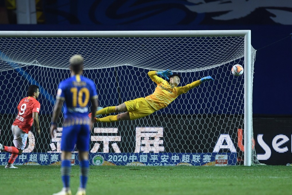 Jiangsu Suning goalkeeper Gu Chao dives during the match between Jiangsu Suning and Guangzhou Evergrande in the Chinese Super League. Photo: Xinhua