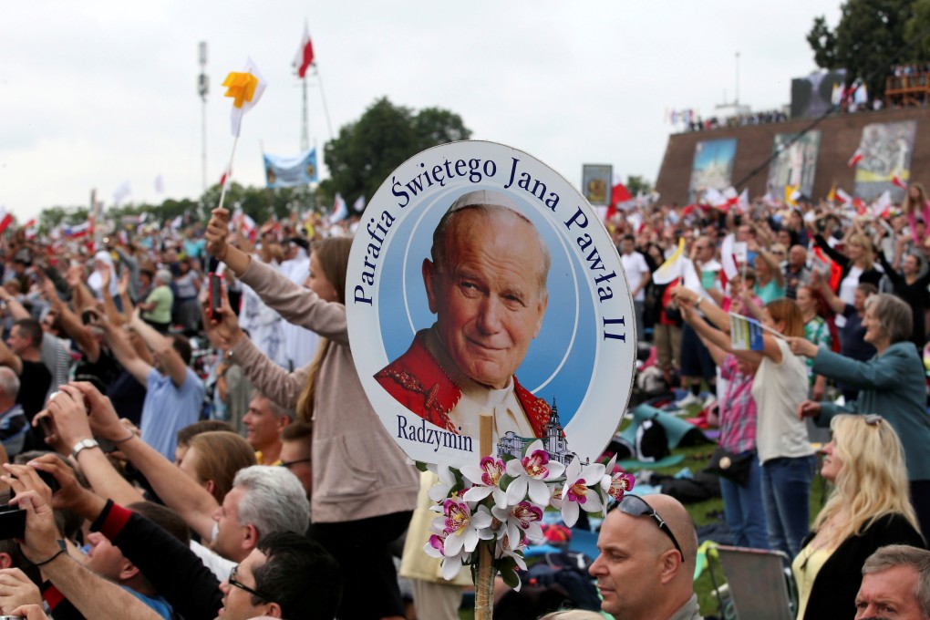 A member of the faithful holds a picture of Pope John Paul II at the Jasna Gora shrine in Czestochowa, Poland in 2016. The pope died in 2005 after a 27-year reign. Photo: Reuters