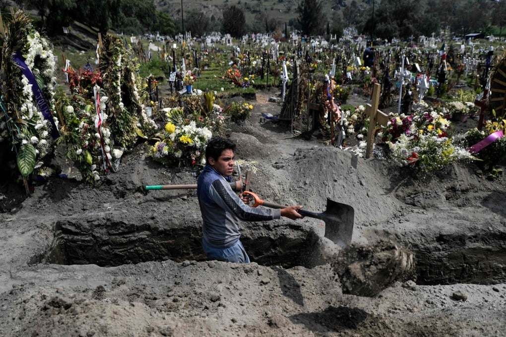 A gravedigger works at the San Miguel Xico cemetery in Mexico on Thursday, amid the Covid-19 coronavirus pandemic. Photo: AFP