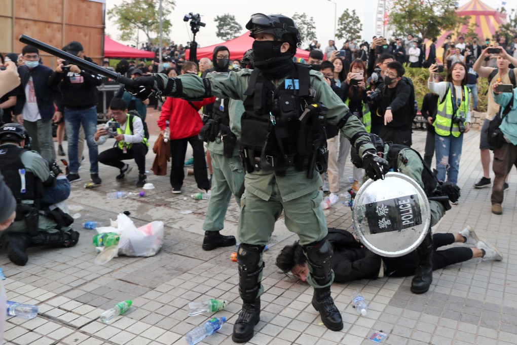 Police detain a protester after a Chinese flag was removed from a flagpole at a rally in support of Xinjiang Uygurs’ human rights in Hong Kong last year. Photo: Reuters