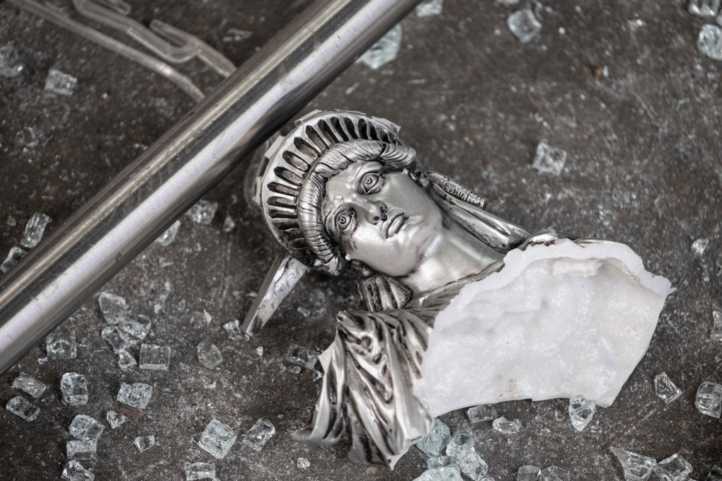 A broken Statue of Liberty figure is seen amid glass shards outside a looted souvenir shop in New York City, after a night of protests on June 2 over the death of George Floyd. Is the world seeing the end of the aura of American exceptionalism that has given the dollar Teflon-like resilience for most of the post-World War II era? Photo: AFP