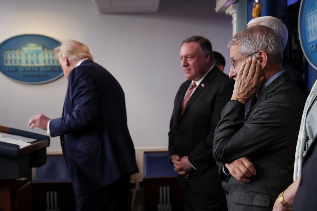 America’s top infectious diseases expert, Dr Anthony Fauci (in glasses), listens as President Donald Trump addresses a coronavirus response briefing in March. Photo: Reuters