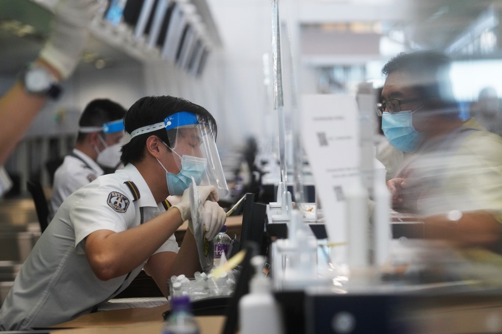 An airport employee hands over his sample for Covid-19 testing at Hong Kong International Airport. Photo: Winson Wong