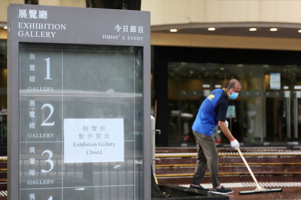 A cleaner disinfects the area outside the Hong Kong Central Library in Causeway Bay on August 13. The Minimum Wage Commission failed to reach a consensus on a raise during its most recent meeting. Photo: Nora Tam